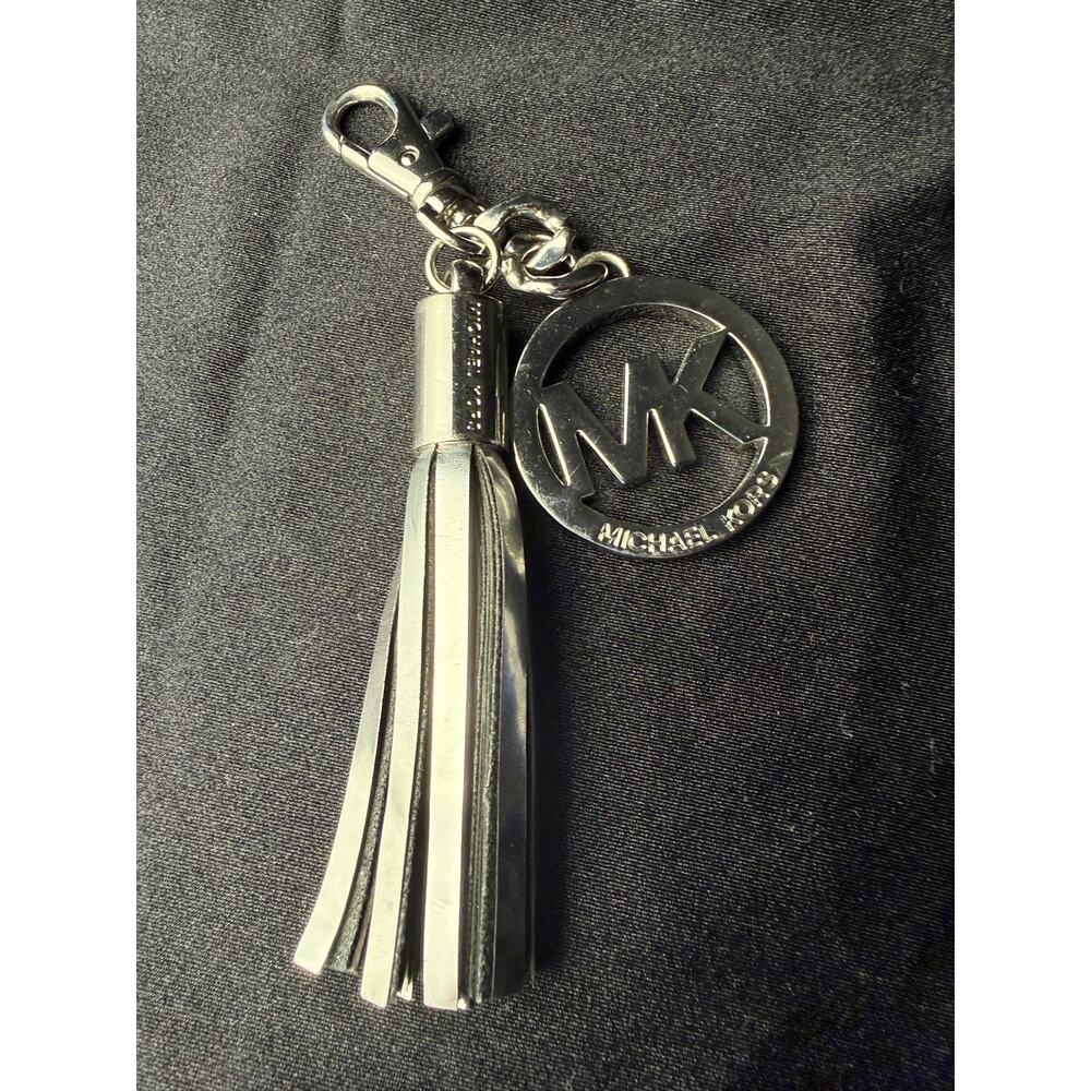 Michael Kors silver bag charm and key chain with patent finished fringe tassel